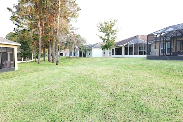 view of yard with glass enclosure