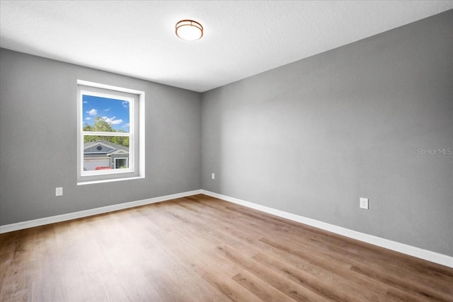 unfurnished room featuring hardwood / wood-style floors