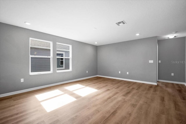 empty room with hardwood / wood-style floors