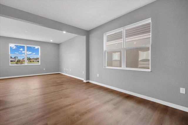 unfurnished room with wood-type flooring