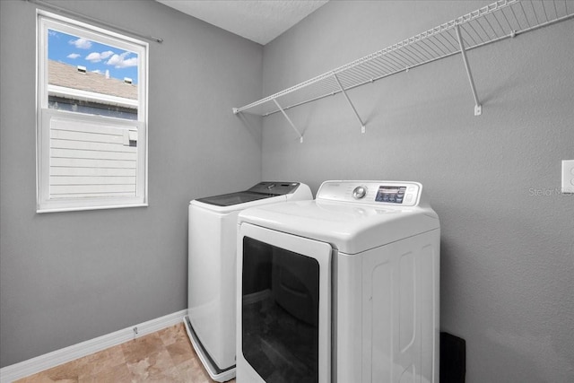 clothes washing area featuring washer and clothes dryer