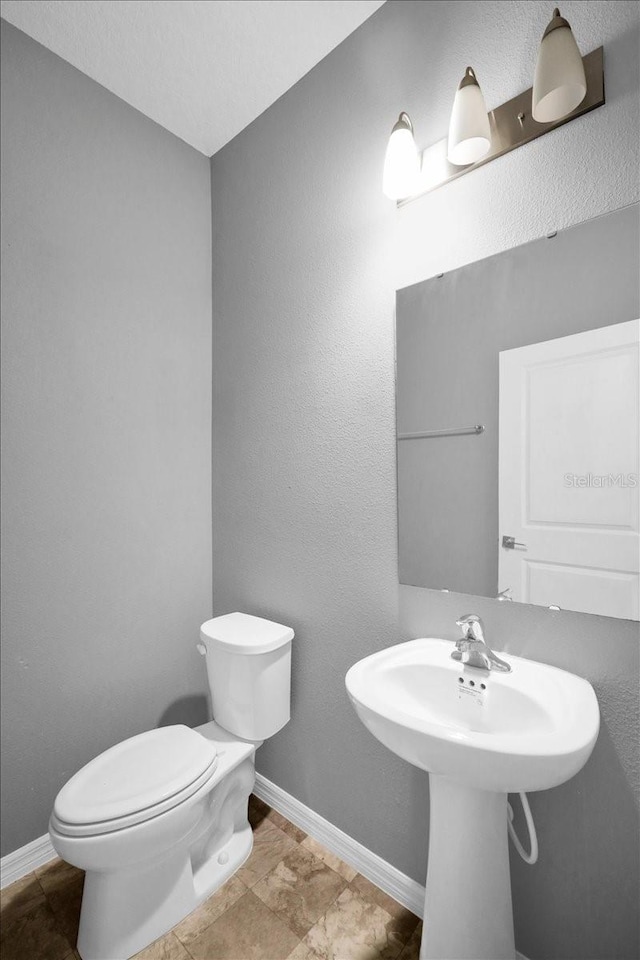 bathroom with tile patterned floors and toilet