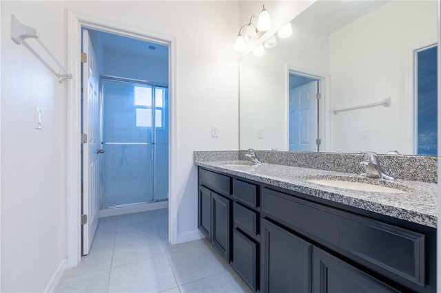 bathroom with tile patterned floors, vanity, and walk in shower