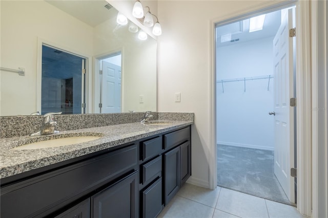 bathroom featuring tile patterned flooring and vanity