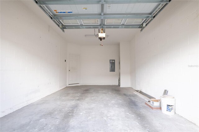 garage with electric panel and a garage door opener