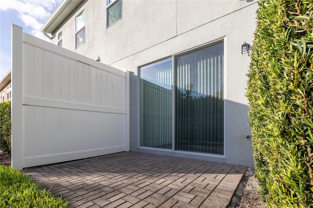 view of gate with a patio area