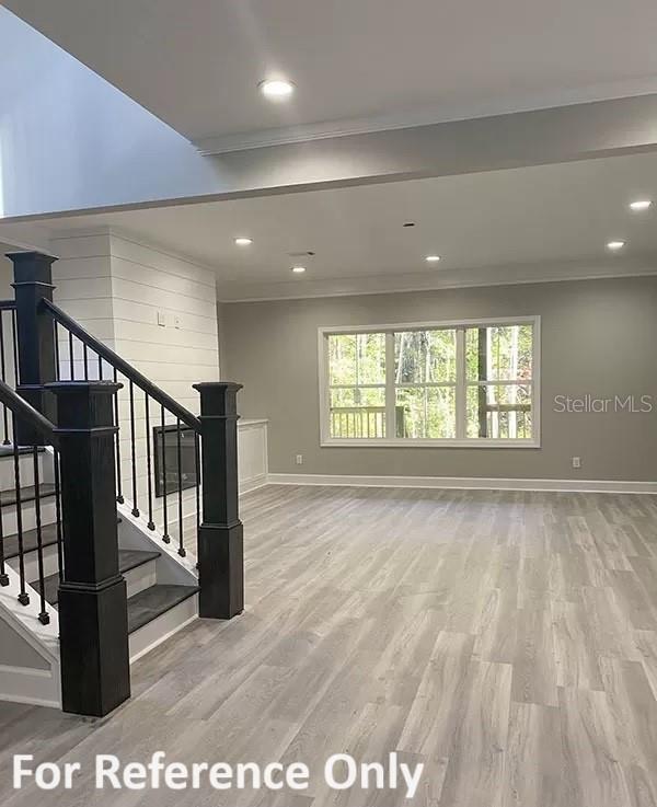 interior space featuring hardwood / wood-style floors and ornamental molding