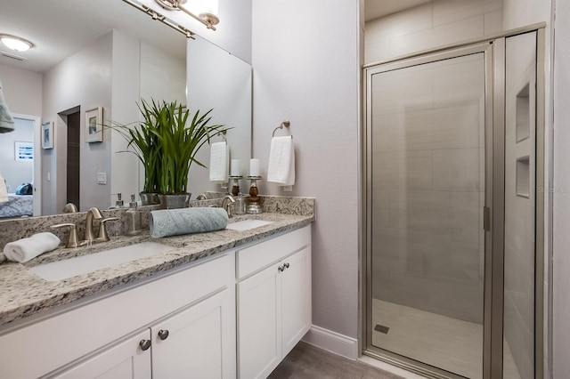 full bathroom with connected bathroom, a sink, a shower stall, and double vanity