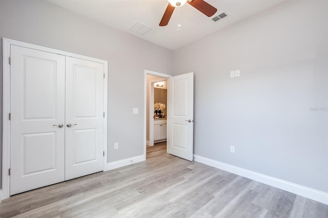 unfurnished bedroom featuring light wood finished floors, visible vents, and baseboards