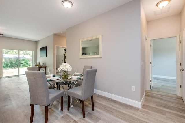 dining room with light wood-type flooring and baseboards