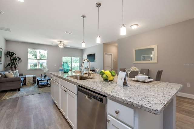 kitchen with light wood finished floors, visible vents, open floor plan, stainless steel dishwasher, and a sink