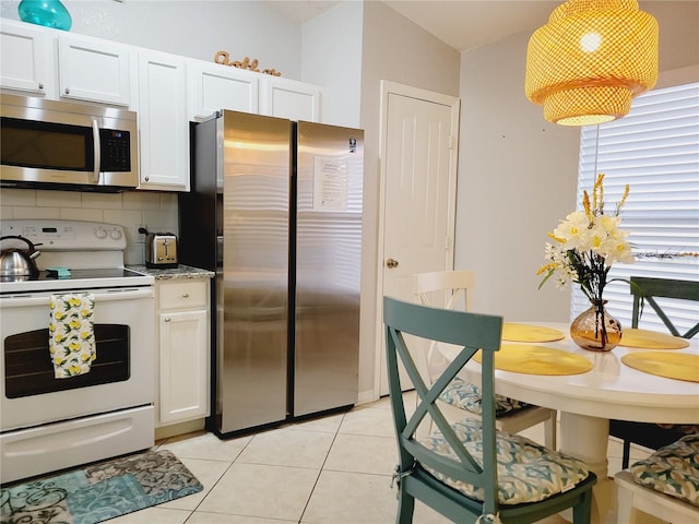 kitchen featuring backsplash, light tile patterned flooring, white cabinets, and stainless steel appliances