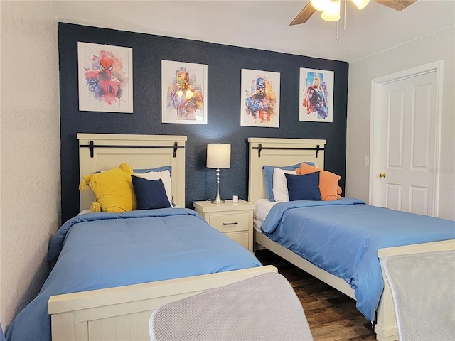 bedroom with ceiling fan and dark hardwood / wood-style flooring