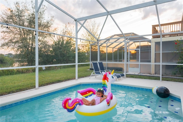 view of swimming pool featuring a lanai