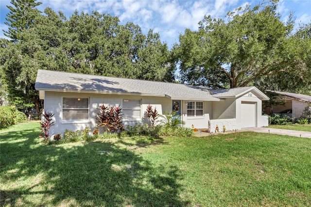 single story home featuring a garage and a front lawn