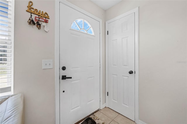 foyer entrance with light tile patterned floors