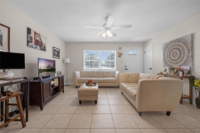 tiled living room with ceiling fan and a textured ceiling