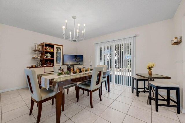 tiled dining area featuring a notable chandelier