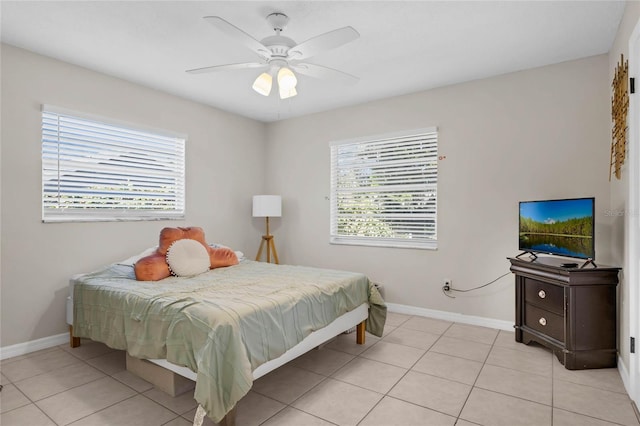 tiled bedroom with multiple windows and ceiling fan