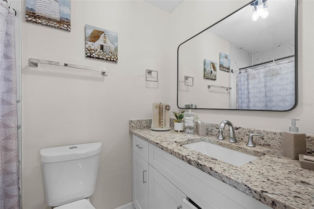 bathroom featuring vanity, toilet, and curtained shower