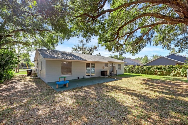 rear view of property with a patio area and central AC unit