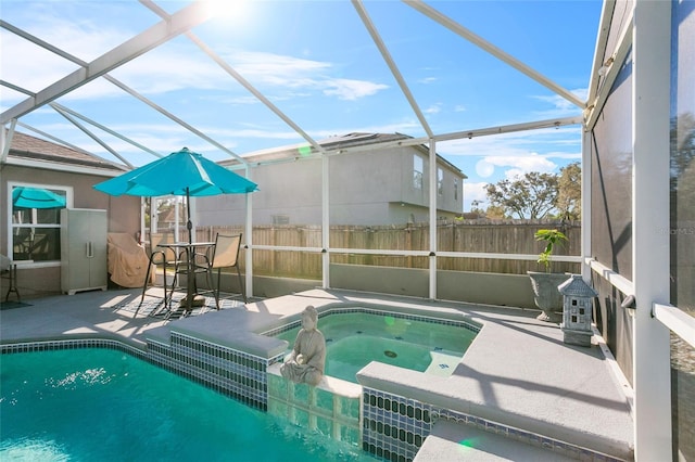 view of pool featuring a patio area, a jacuzzi, and glass enclosure