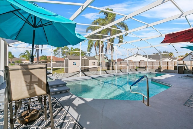 view of swimming pool with a lanai, a patio, and a storage unit