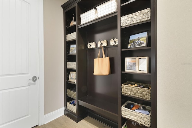 mudroom featuring wood finished floors and baseboards