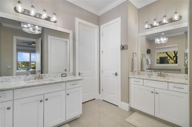 ensuite bathroom with crown molding, two vanities, a sink, and ensuite bathroom