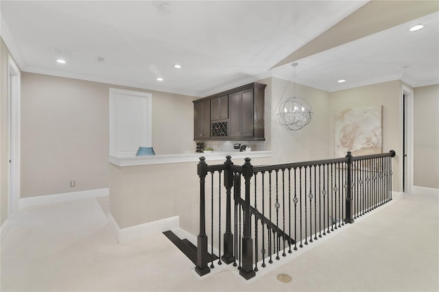 corridor featuring baseboards, ornamental molding, and recessed lighting