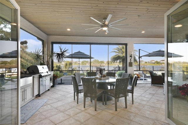 sunroom with wooden ceiling and a ceiling fan