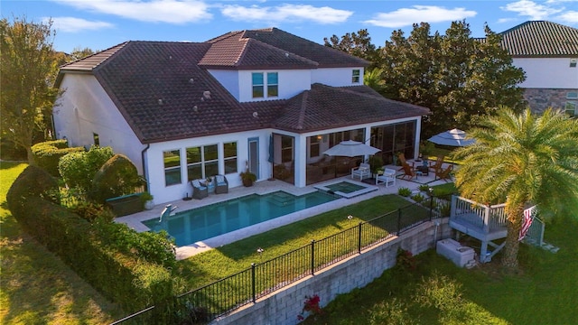 back of house with a patio, a fenced backyard, a tiled roof, a lawn, and stucco siding