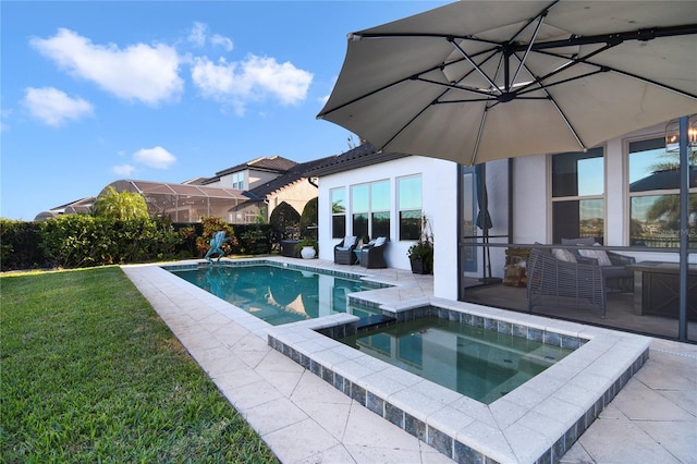 view of pool featuring a patio, a lawn, and a pool with connected hot tub