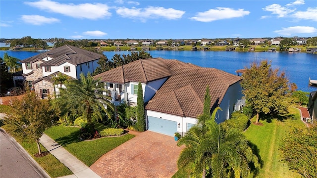 drone / aerial view with a water view and a residential view