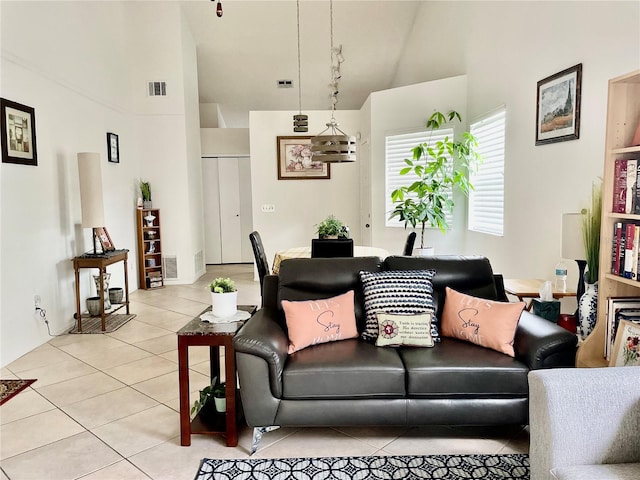 tiled living room featuring a high ceiling