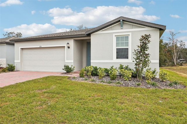 view of front of home with a front yard and a garage