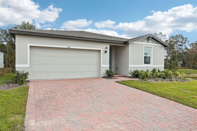 ranch-style home with a front yard and a garage