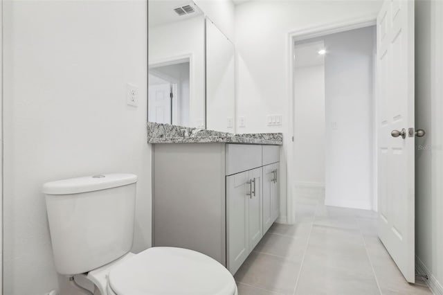 bathroom featuring tile patterned floors, vanity, and toilet