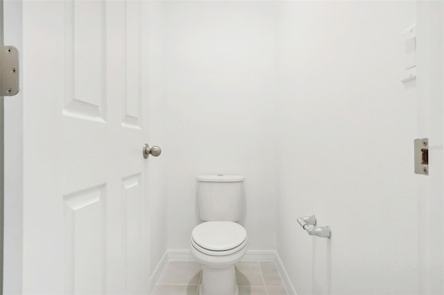 bathroom with tile patterned flooring and toilet