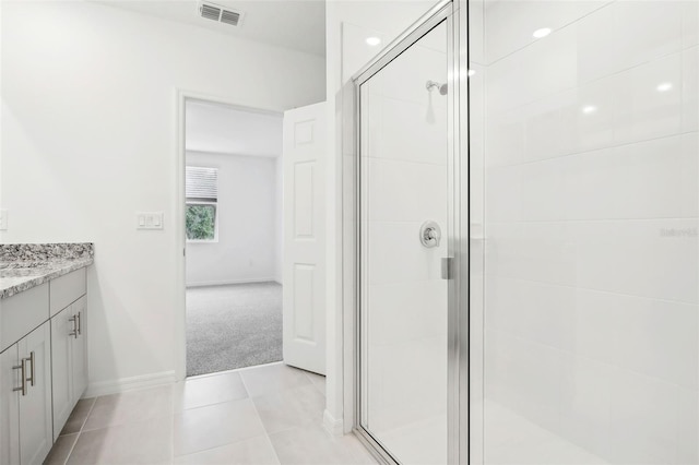 bathroom with tile patterned flooring, vanity, and a shower with shower door