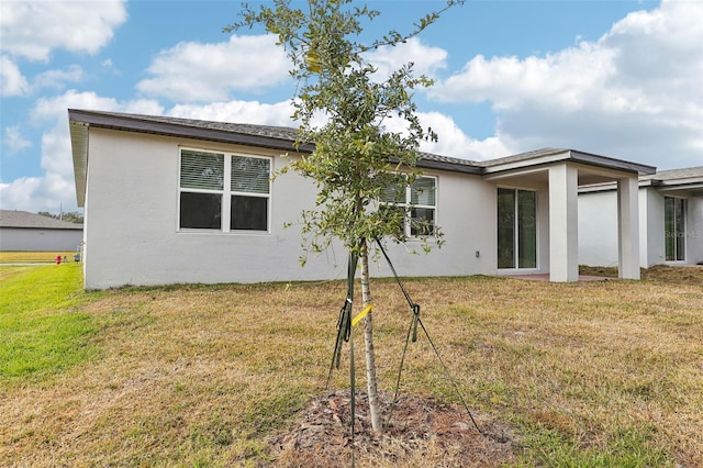 rear view of property featuring a yard