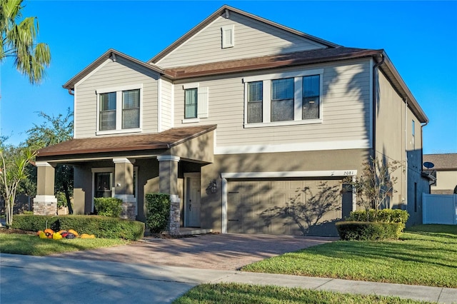 view of front of house with a garage and a front yard