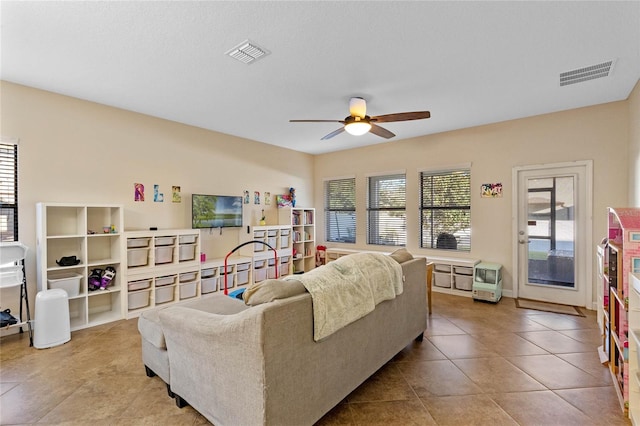 tiled living room featuring ceiling fan