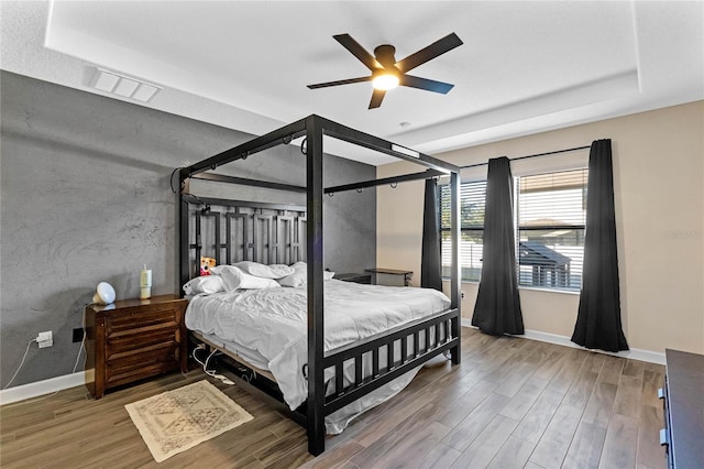 bedroom with ceiling fan and hardwood / wood-style floors