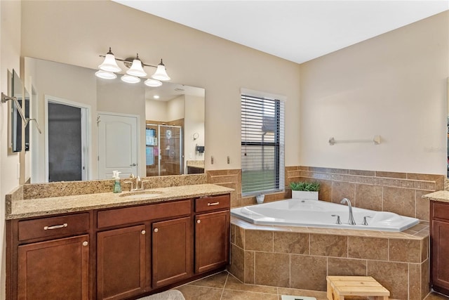 bathroom with tile patterned floors, vanity, and shower with separate bathtub