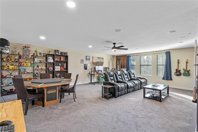 living room with ceiling fan, light colored carpet, and a textured ceiling