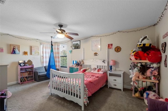 carpeted bedroom with a textured ceiling and ceiling fan