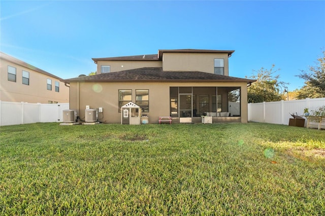 back of house featuring a lawn, a sunroom, and cooling unit