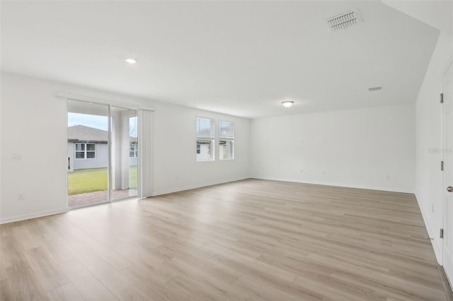 empty room featuring light hardwood / wood-style floors and plenty of natural light