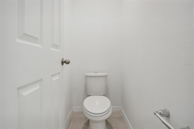 bathroom with toilet and tile patterned floors